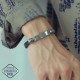 Черна кожена гривна със стоманена плочка и два черепа